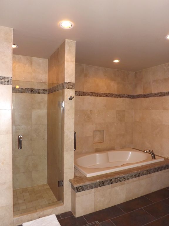 Large soaker tub and tiled shower bathroom