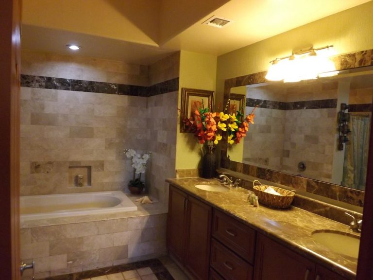 Gorgeous two sink vanity in this tile-clad bathroom