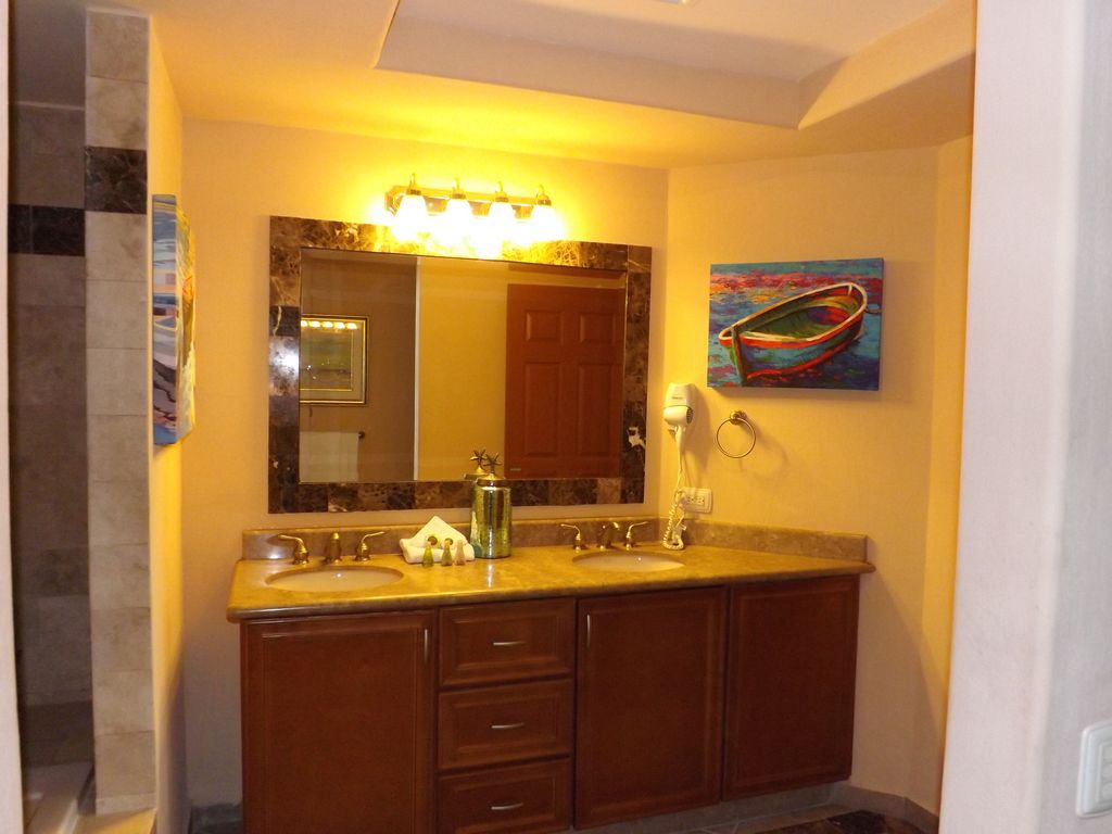 This bathroom is equipped with a large dual sink vanity