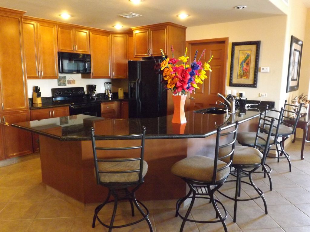 Generous full-size kitchen with bar area has enough space for you and your guests