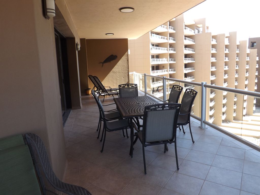 A large 6 person outdoor eating space adorns one balcony